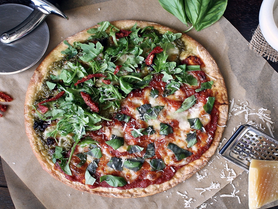 Pizza with red sauce and basil
